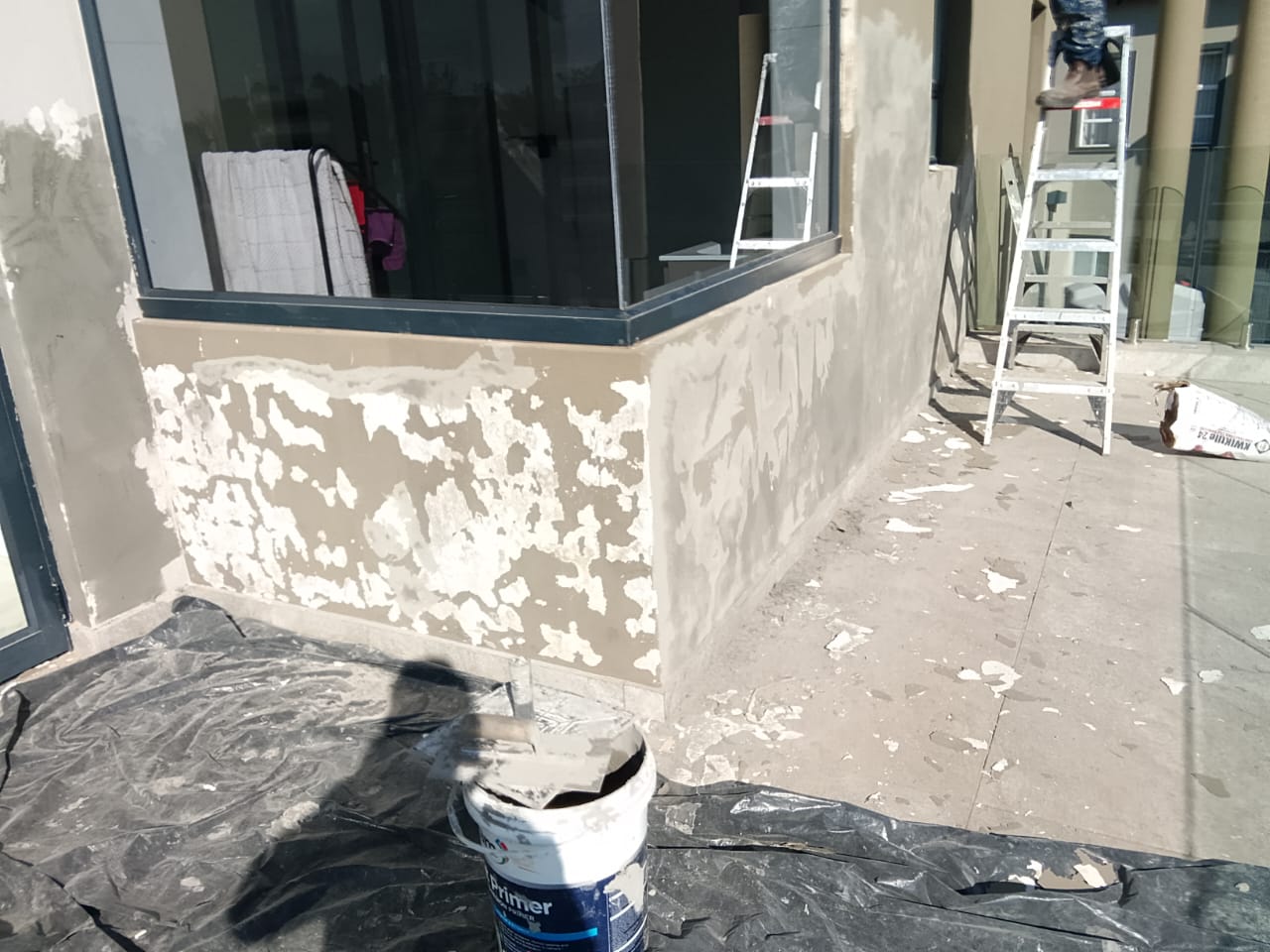 exterior corner of house being prepped for painting